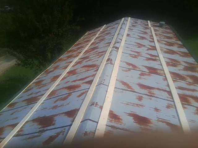 Rusted metal roof panels with new wood purlins before replacement — Storm Damage Roof Repair in York Haven by Roofing Brothers