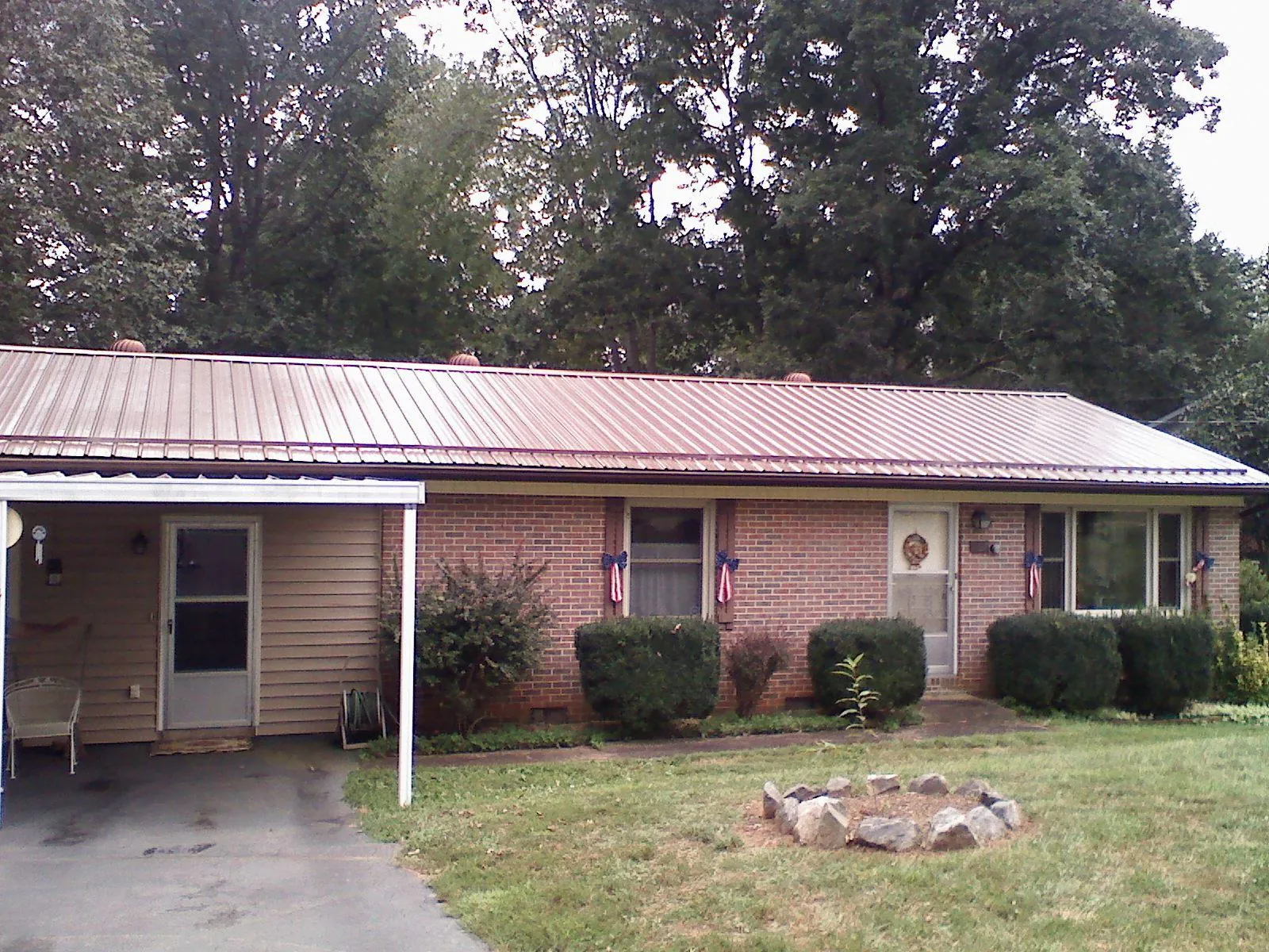 Bronze metal roof and carport on a brick ranch home — Roof Repair work by our crew in York Haven