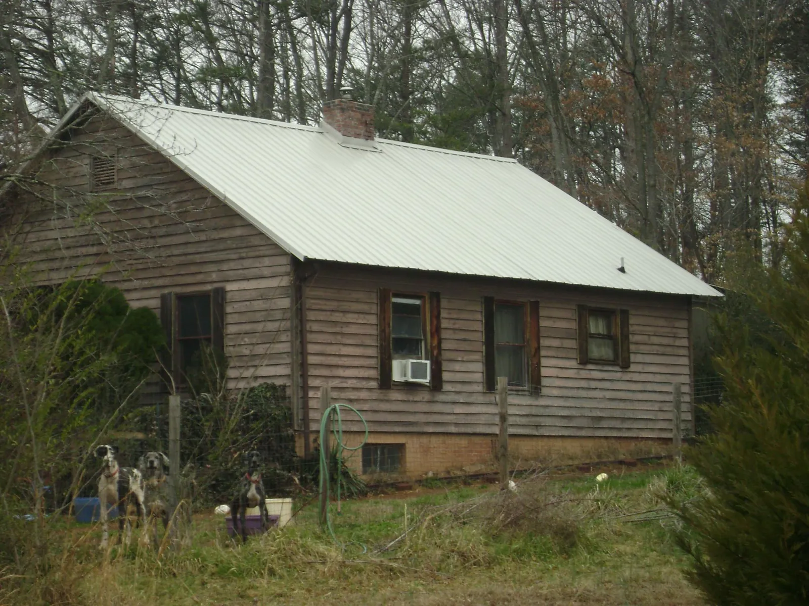 White metal roof on an old wood sided farmhouse, from a Asphalt Shingle Roof Repair job in York Haven
